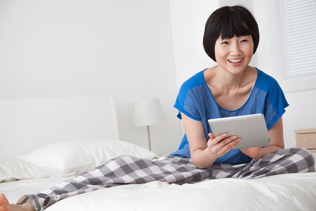 Chinese Woman searching on tablet